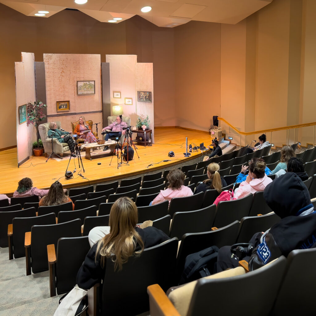 Live recording of the Thoughtful Connections memory care podcast at Cottey College as Elizabeth Thompson and Charlie Johnson speak on stage before an audience.